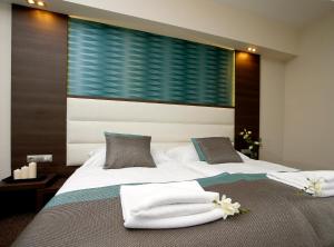 Posteľ alebo postele v izbe v ubytovaní Hotel Villa Völgy Wellness & Konferencia