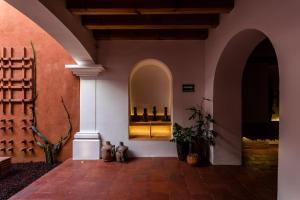 a room with two cats sitting on the floor in a building at Hotel Ayook in Oaxaca City