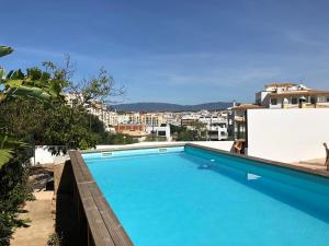 a large blue swimming pool on top of a building at Quinta da Paz B&B in Portimão