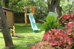 a playground with a slide and a play structure at Hotel-Restaurant Weinberg in Artern