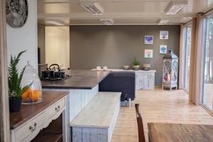 a large kitchen with a counter and a table at Zakątek Nad Jeziorem in Łyśniewo +8 photos