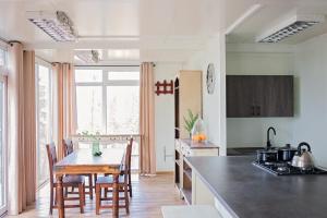 a kitchen with a table and some chairs in a room at Zakątek Nad Jeziorem in Łyśniewo