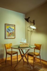 a dining room with a table and two chairs at Hotel Alpenruhe - Vintage Design Hotel in Wengen