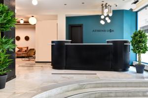 a living room filled with furniture and a tv at Athens One Smart Hotel in Athens