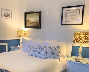 a bedroom with a white bed with two lamps at Acadia Hotel - Downtown in Bar Harbor
