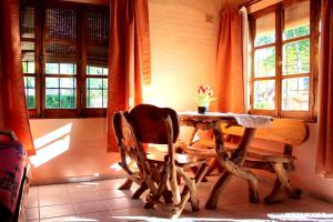 a dining room with a table and chairs and windows at Cabañas Calderón II in San Rafael +13 photos