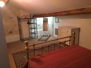 a view of a bedroom with a bed and a mirror at Apart d'Arc in Saintes