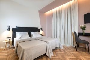 a bedroom with a large bed with white sheets at Athens One Smart Hotel in Athens