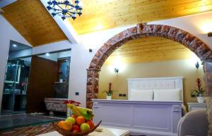 an archway in a room with a bowl of fruit on a table at Villa Parku Rinia in Korçë