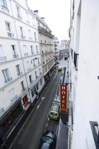 a view of a city street with cars and buildings at HOTEL DU MONT LOUIS in Paris