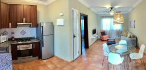 a kitchen with a refrigerator and a table and chairs at Punta Cana Seven Beaches in Punta Cana +17 photos