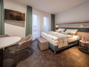 Ein Bett oder Betten in einem Zimmer der Unterkunft RS-HOTEL - smart & modern Hotel Apartments