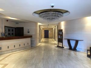 an empty hallway with a chandelier in a building at Rimal Retreat by JS - Deluxe 1 BD Apartment in Dubai