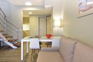 a living room with a white table and chairs at Aqualuz Lagos by The Editory in Lagos