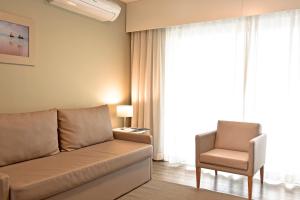 a living room with a couch and a chair at Aqualuz Lagos by The Editory in Lagos