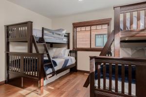 a bedroom with two bunk beds and a staircase at Mountainside 5 in Mammoth Lakes