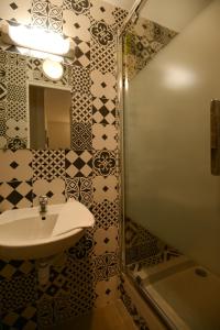 a bathroom with a sink and a shower at HOTEL DU MONT LOUIS in Paris