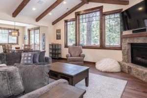 a living room with a couch and a fireplace at Gray Bear 454 in Mammoth Lakes