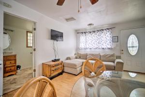 a living room with a couch and a glass table at Lakefront Geneva Vacation Rental - Walk to Strip! in Geneva-on-the-Lake