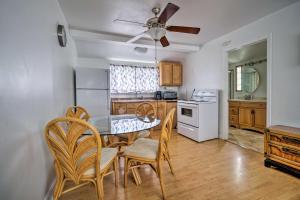 a kitchen with a table and chairs and a ceiling fan at Lakefront Geneva Vacation Rental - Walk to Strip! in Geneva-on-the-Lake