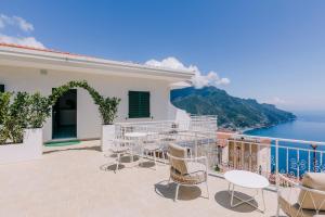 a balcony with chairs and a view of the ocean at Casa Dolce Casa in Ravello