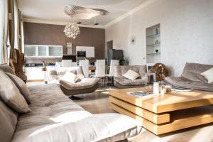 a living room with a couch and a table at Residence du Louvre - Apartments - Prime location Palais & Croisette - Luxury Stay by LRA Cannes in Cannes
