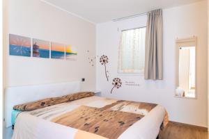 A bed or beds in a room at Appartamento Vicino al Mare