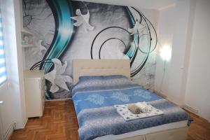 Apartman Aleksandar tesisinde bir odada yatak veya yataklar