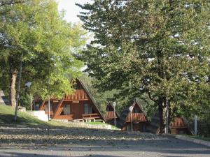 a house with trees and a road in front of it at Domki Brda in Karpacz