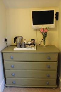 a dresser with a television on top of it at Longmead House in Lynton