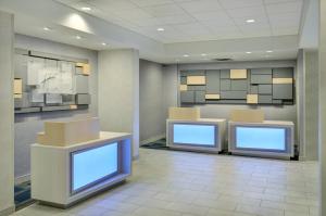 a waiting room with two counters with blue screens at Holiday Inn Express Toronto Downtown, an IHG Hotel in Toronto