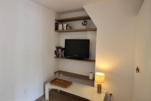 a living room with a tv on a wall at 103275 - Appartement 4 personnes Temple - République in Paris