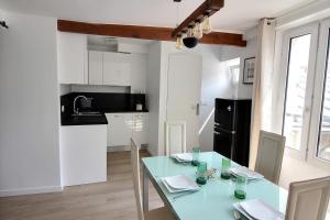 a kitchen and dining room with a table and chairs at 103275 - Appartement 4 personnes Temple - République in Paris