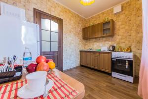 a kitchen with a table with fruit on it at Apartments near metro Osokorki, Borispol Airport, Adonis Clinic in Kyiv