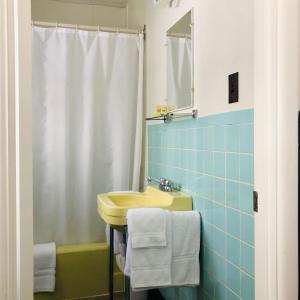 a bathroom with a yellow sink and a mirror at The Voy in Schreiber +22 photos