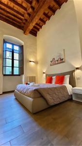 a bedroom with a large bed and a window at Santa Croce apt in Florence