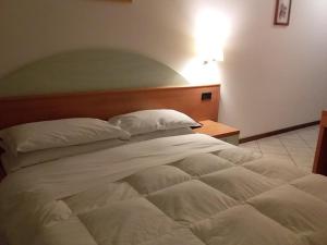 Rúm í herbergi á Hotel Il Cammino Di Francesco
