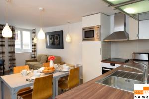 a kitchen and living room with a table and chairs at 202419 - Elegant apartment for 6 people in the Montorgueil area in Paris