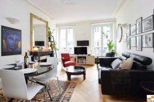 a living room with a couch and a table at 204340 - A two-room apartment with traditional chic style in the Marais in Paris