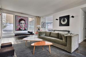 a living room with a couch and a table at 502254 - Spacious duplex apartment for 12 people near Les Halles in Paris