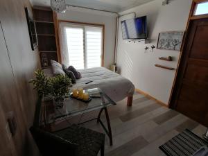 a bedroom with a bed and a glass table at Espacio Innata in Punta Arenas