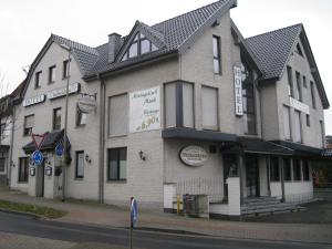 a large building on the corner of a street at Hotel Restaurant "Waldschänke" in Wassenberg