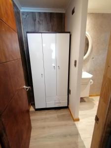 a bathroom with a white cabinet and a toilet at Espacio Innata in Punta Arenas +17 photos