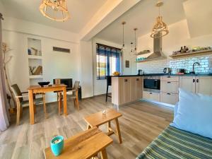 a kitchen and living room with a couch and a table at Villa Thalassa in Triopetra
