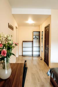 a living room with a vase of flowers on a table at Villa Kmeller in Lviv