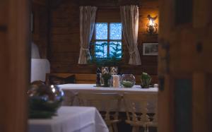 a dining room with two tables and a window at hotel & chalet madlochBlick in Lech am Arlberg