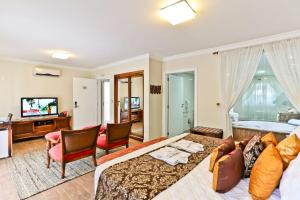 a bedroom with a bed and a living room at Estaleiro Guest House in Balneário Camboriú