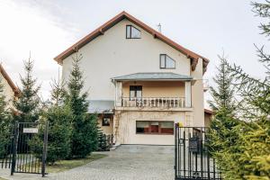 a house with a gate in front of it at Villa Kmeller in Lviv