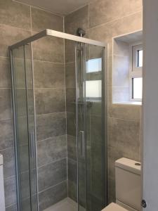 a bathroom with a shower, toilet, and sink at Zen House Bath in Bath