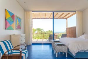 a bedroom with a bed and a view of the ocean at Bahia Vik in José Ignacio